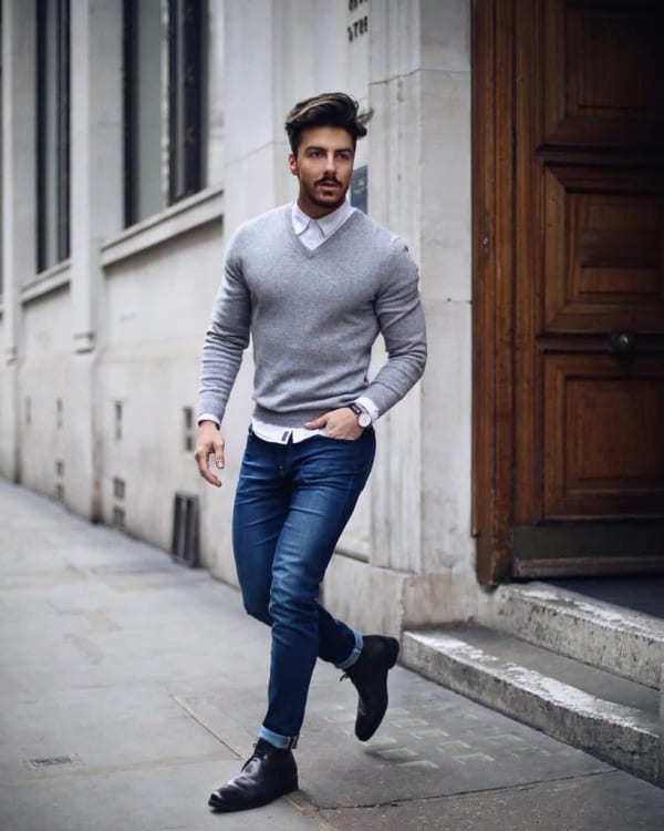 Urban asian man. Good looking. Cool guy. Wearing grey shirt and hat and  jeans. Standing in front of brick wall. - Stock Image - Everypixel