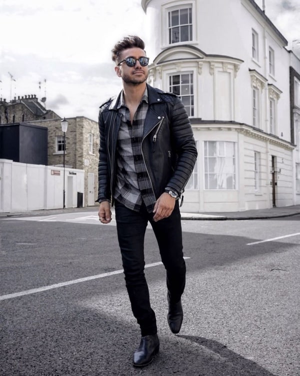 Stylish Fashionable Young Guy In A Denim Fashion Jacket With Black Pants  And Shoes Sitting Near A Wooden House Stock Photo - Download Image Now -  iStock